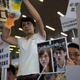 Beijing supporters hold pictures of Baggio Leung and Yau Wai-ching on a placard that reads “Get out of Chinese land immediately” during a protest outside the Legislative Council in Hong Kong, 19 October 2016.